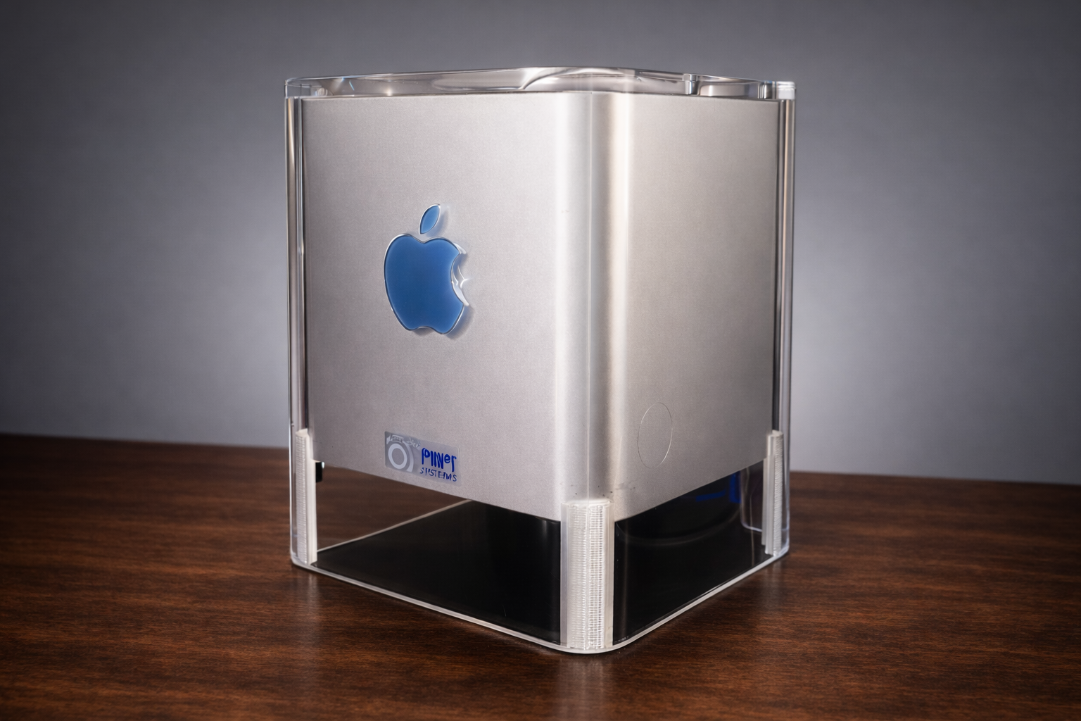 Power Mac G4 Cube on walnut surface